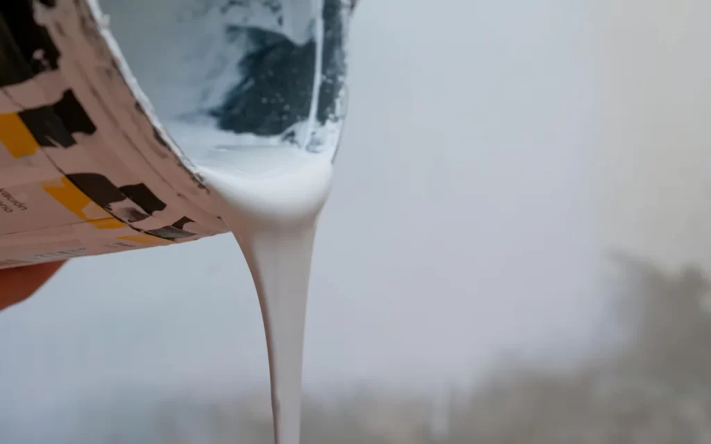 Old paint cans with dried paint being prepared for safe disposal
